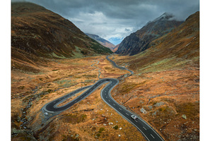 Aerial view of winding road in high, a Transportation Photo by den-belitsky