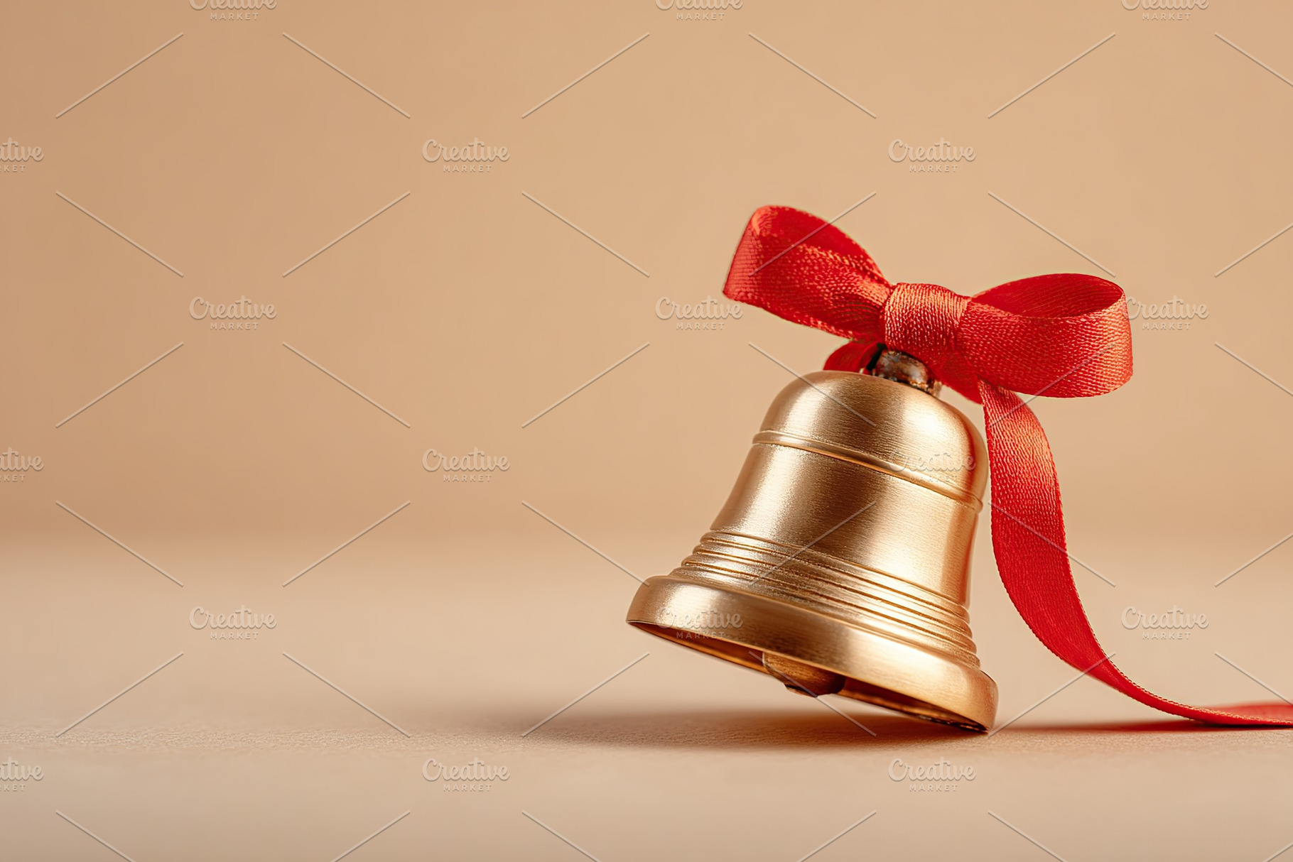 Decorative bell with red ribbon on soft background in festive season setting, a Photo by AlyaAnd