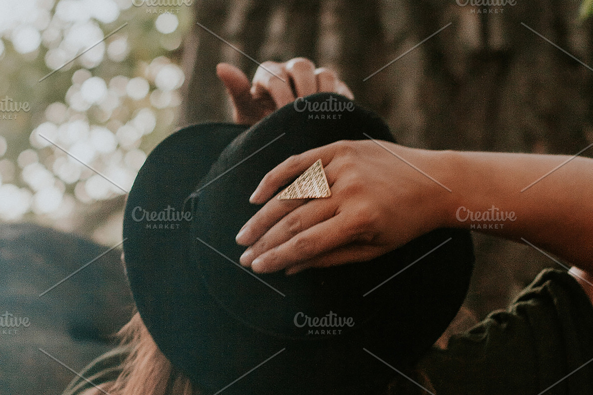 Woman with hands on her hat, a Person Photo by Wild Wander Collective (Photo 2 of 2)