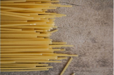 Yellow long spaghetti on an old, a Food & Drink Photo by olhovyi_photographer