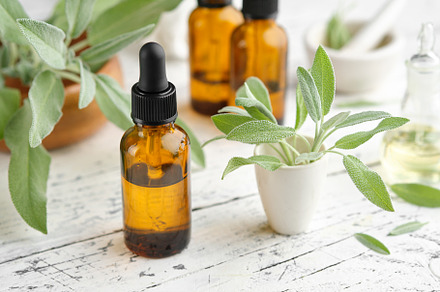 Bottles of sage oil, leaves of sage., a Health & Medical Photo by chamillewhite
