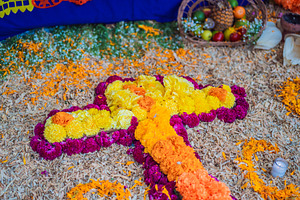 Cross made of bright flowers on a