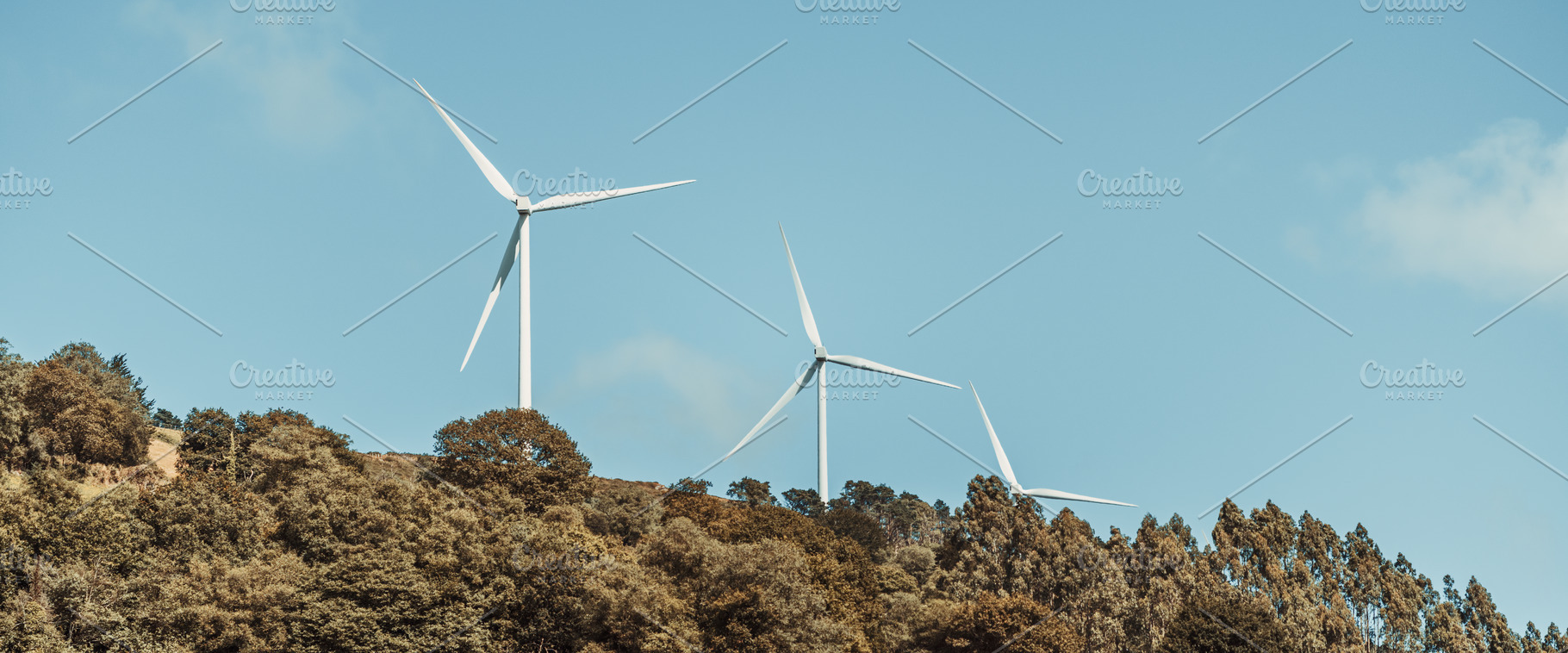 Wind turbines over forest ridge, an Industrial Photo by SkyNext