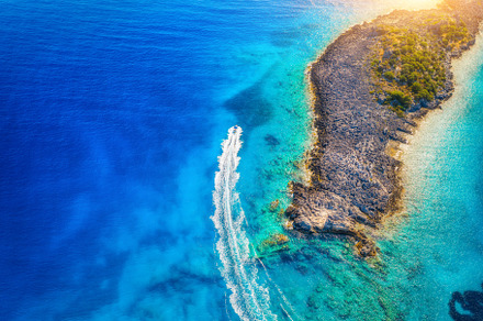 Aerial view of beautiful speed boat on the sea at sunset, a Nature Photo by den-belitsky