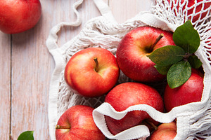 Fresh red apples in reusable shopping bag promoting sustainable, a Food & Drink Photo by Olena Rudo