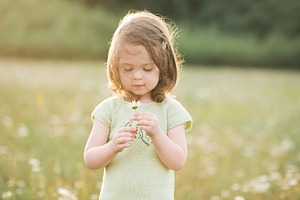 Cute kid girl in meadow