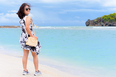Cute teen girl tourist on the beach, a Person Photo by yongkiet jitwattanatam