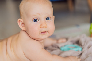 Baby lying on play mat learning to, a Person Photo by Elizaveta Galitskaya
