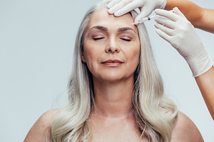 Senior woman getting cosmetic inject, a Beauty & Fashion Photo by Jacob Lund