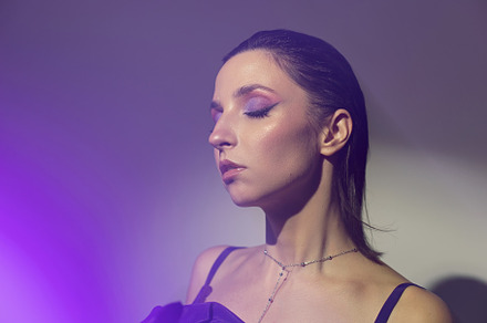 portrait of a brunette woman in a purple dress on white background in the studi, a Person Photo by SaulichPhoto