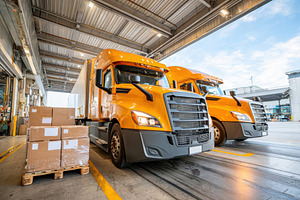 Orange trucks in a warehouse setting, a Transportation Photo by AlyaAnd