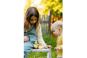 Kids enjoying time with baby animals, a Nature Photo by HalfPoint