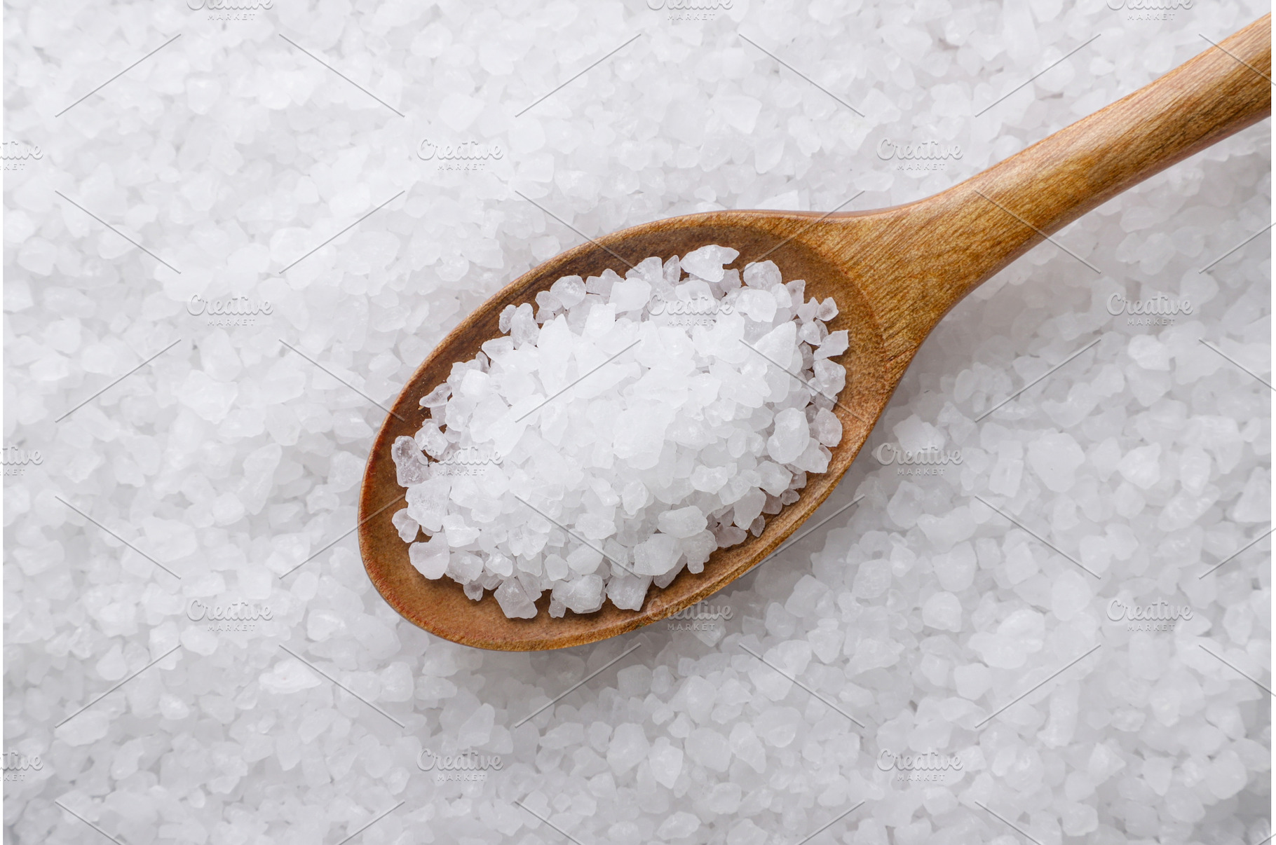 Salt in a wooden spoon background, a Food & Drink Photo by innakreativ