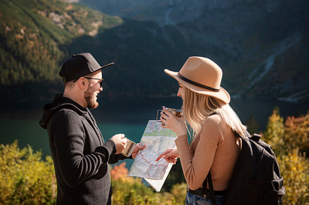 Young tourist couple, man and woman, on hiking path in mountains, a Person Photo by Olena Rudo