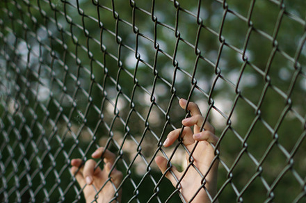 Trapped containing fence, child, and hands