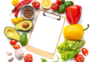 Fresh vegetables and clipboard for healthy meal planning, a Food & Drink Photo by Olena Rudo
