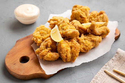 Homemade traditional japanese fried chicken Karaage on a rustic, a Food & Drink Photo by LiudmylaChuhunova