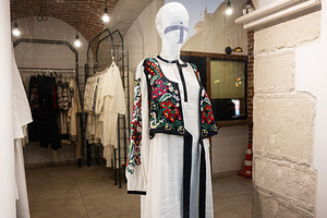 Stylish embroidered ukrainian dress displayed in a boutique with elegant interi, a Photo by AS photostudio