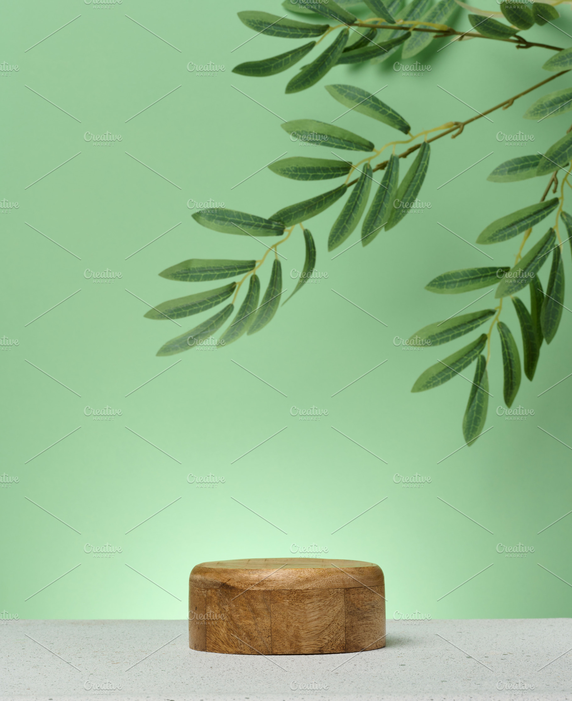Wooden cylindrical podium or display stand sits on green backgro, a Background Photo by ndanko