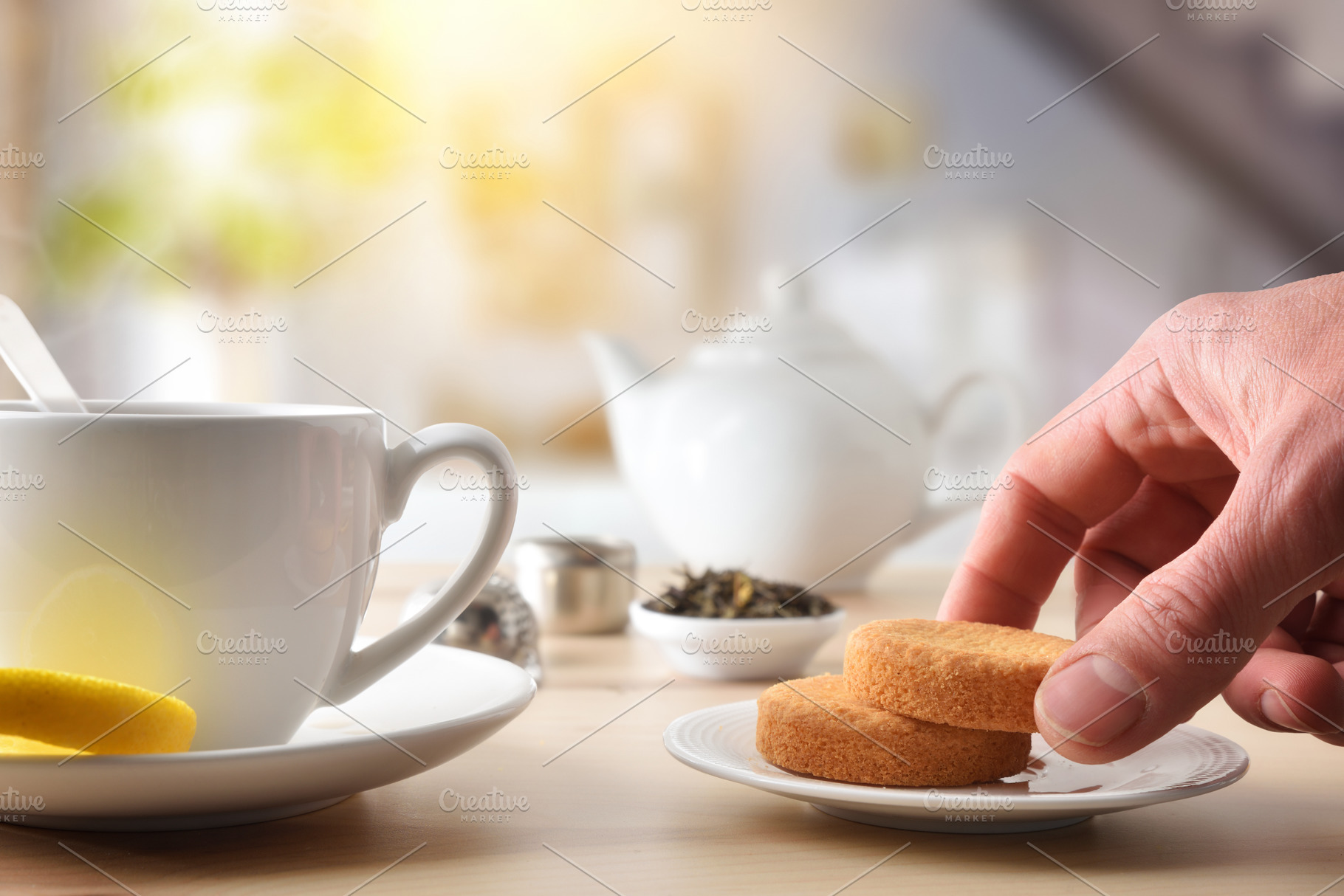 Person's hand taking biscuit from a ceramic plate for breakfast, a Food & Drink Photo by Davizro's Market