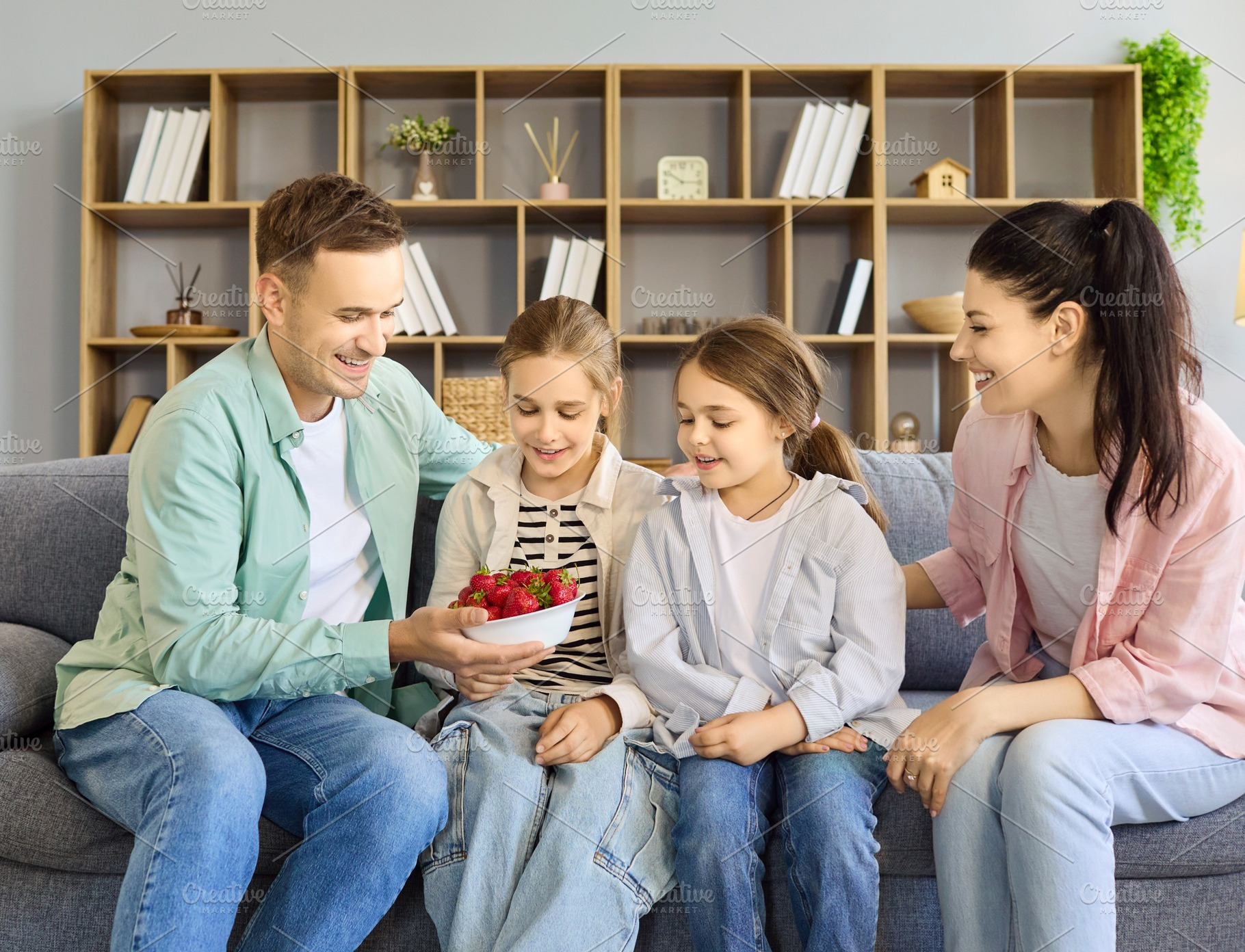 Family Sharing Strawberries on Couch, a Person Photo by StudioRomantic