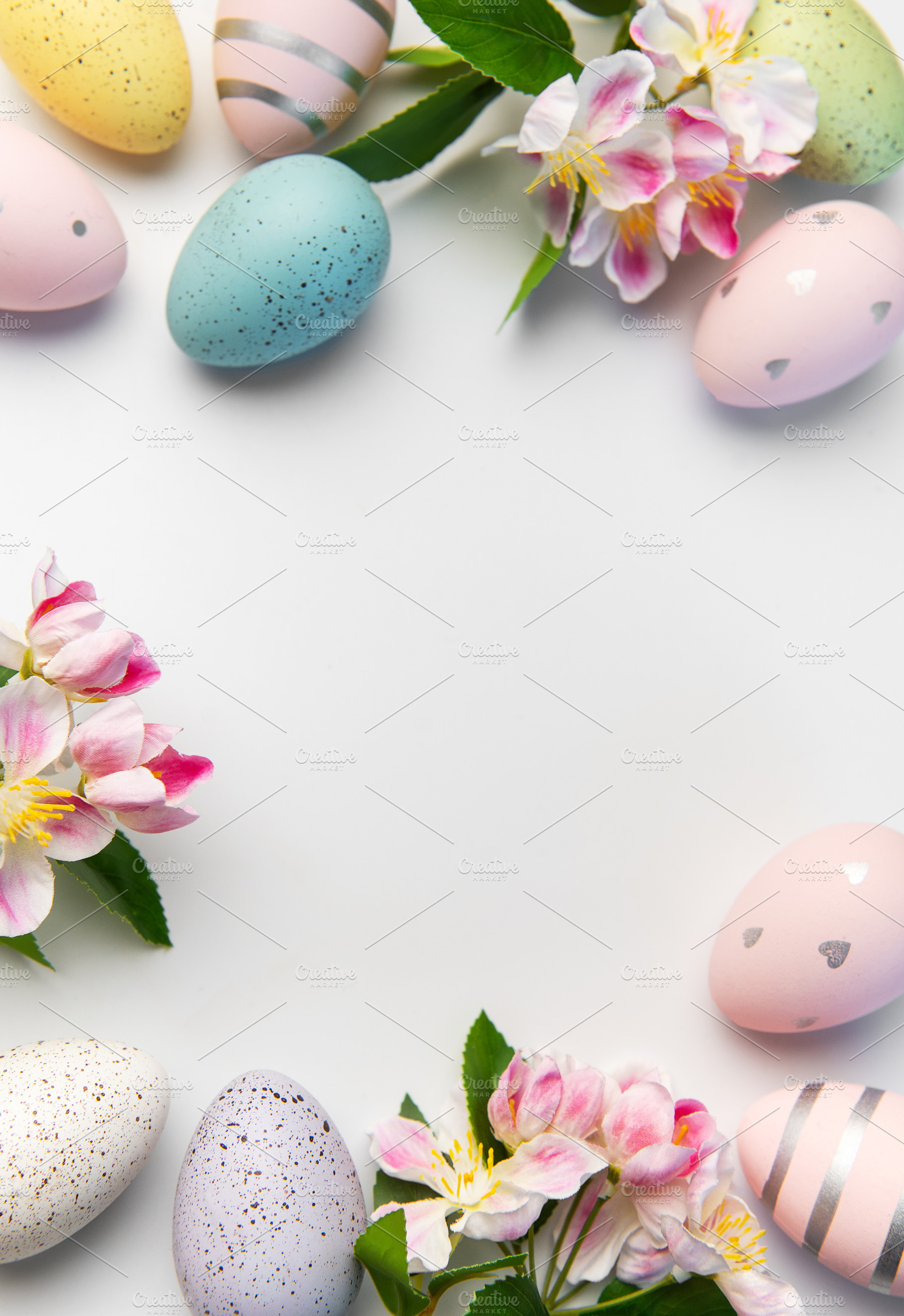 Easter eggs and spring flowers creating border background, a Holiday Photo by Olena Rudo