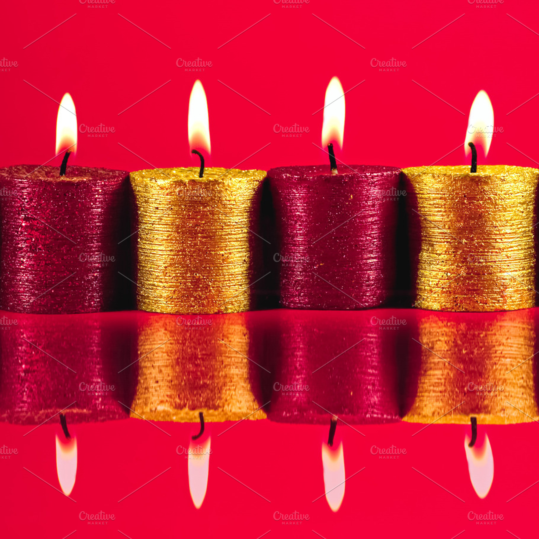 Red and gold candles with bright flames burning, casting reflect, a Photo by Studio ANNA