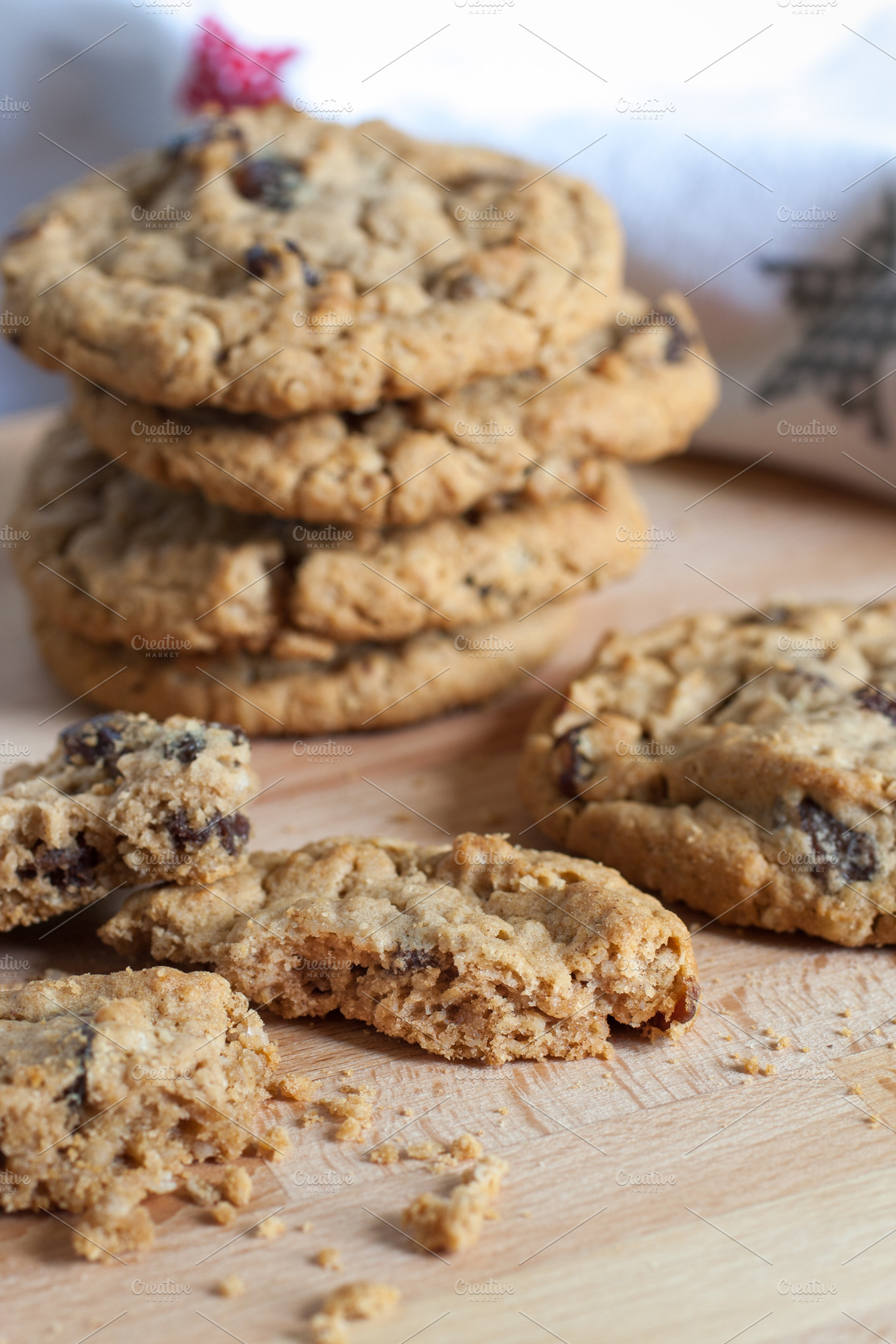 Fresh oatmeal raisin cookies containing baked, board, and brown, a Food & Drink Photo by Southern Light