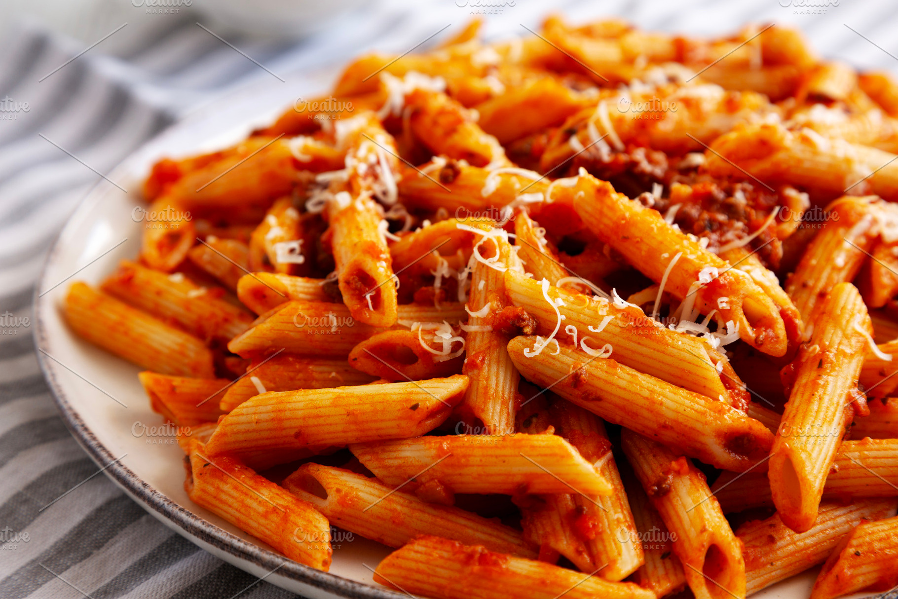 Homemade Pasta Bolognese with Cheese on a Plate, side view. Clos, a Food & Drink Photo by LiudmylaChuhunova