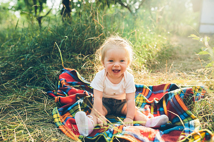 Little girl sitting on the lawn containing alone, beautiful, and female, a Person Photo by Tekso