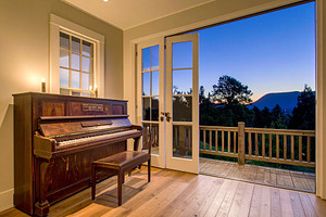 Wooden piano near terrace at night, an Architecture Photo by DanFLCreativo