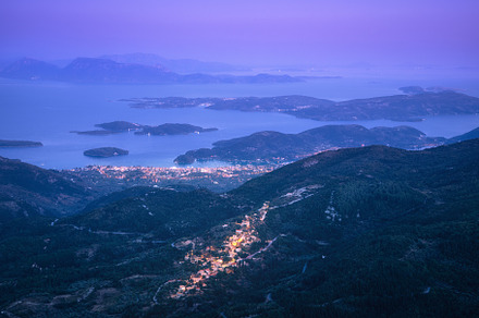 Small village in the mountain and city on the sea cost at night, a Nature Photo by den-belitsky