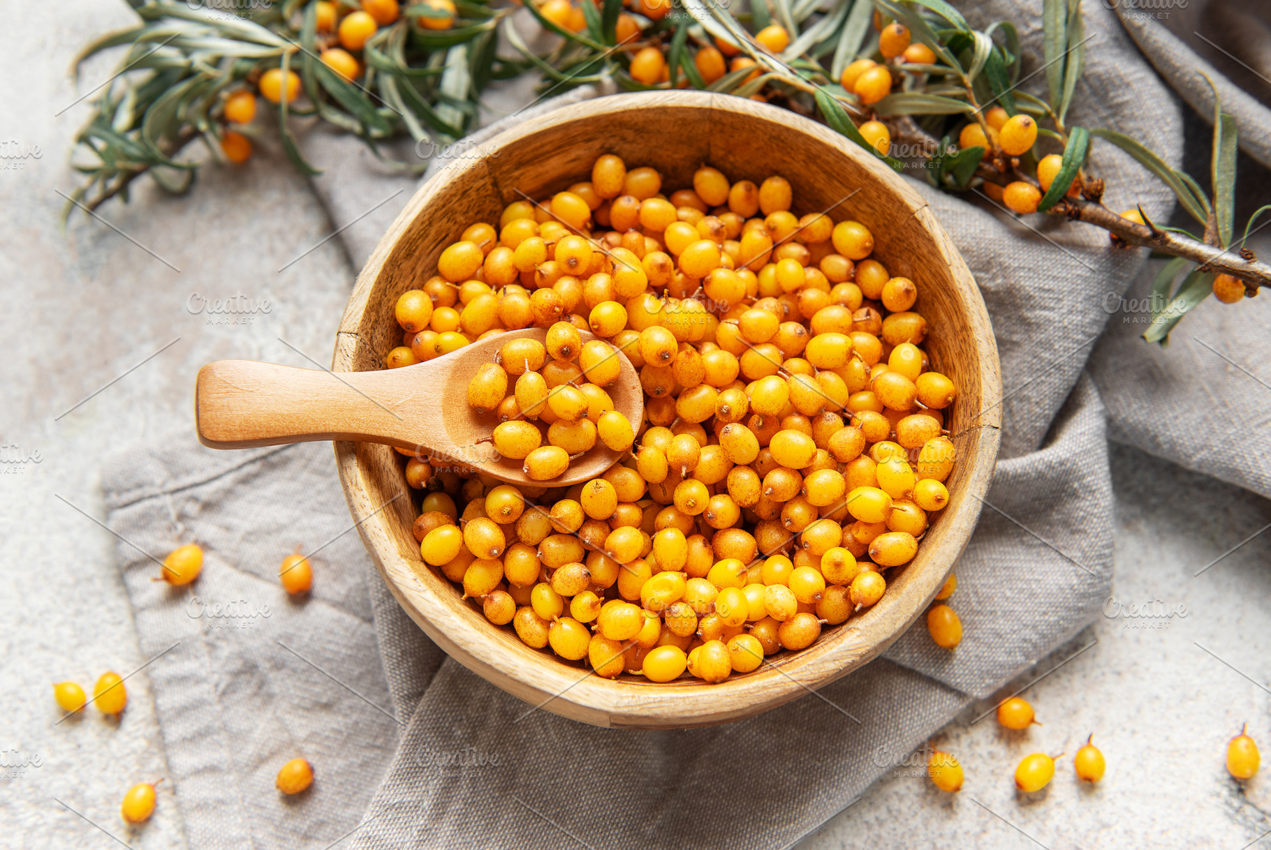 Sea buckthorn berries in wooden bowl, a Food & Drink Photo by Olena Rudo