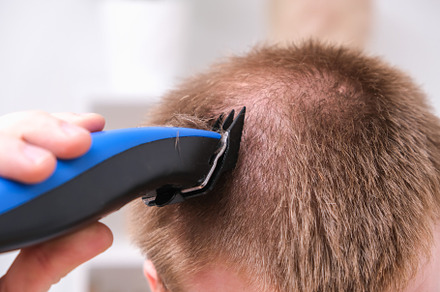 A man cuts his hair with clipper. Cutting a short hairstyle at home. Close-up., a Technology Photo by Detriana