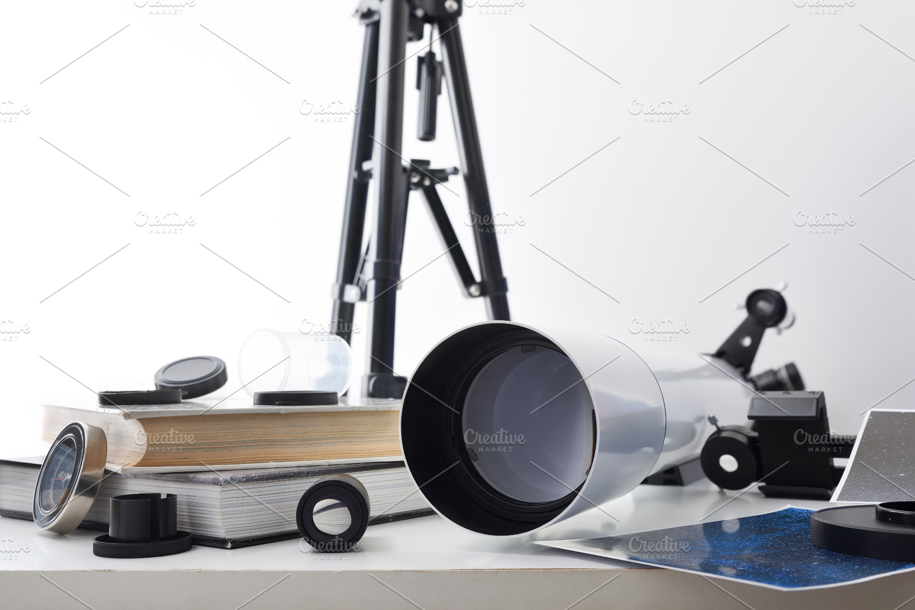 View of a telescope lens on white table with tools, a School & Education Photo by Davizro's Market