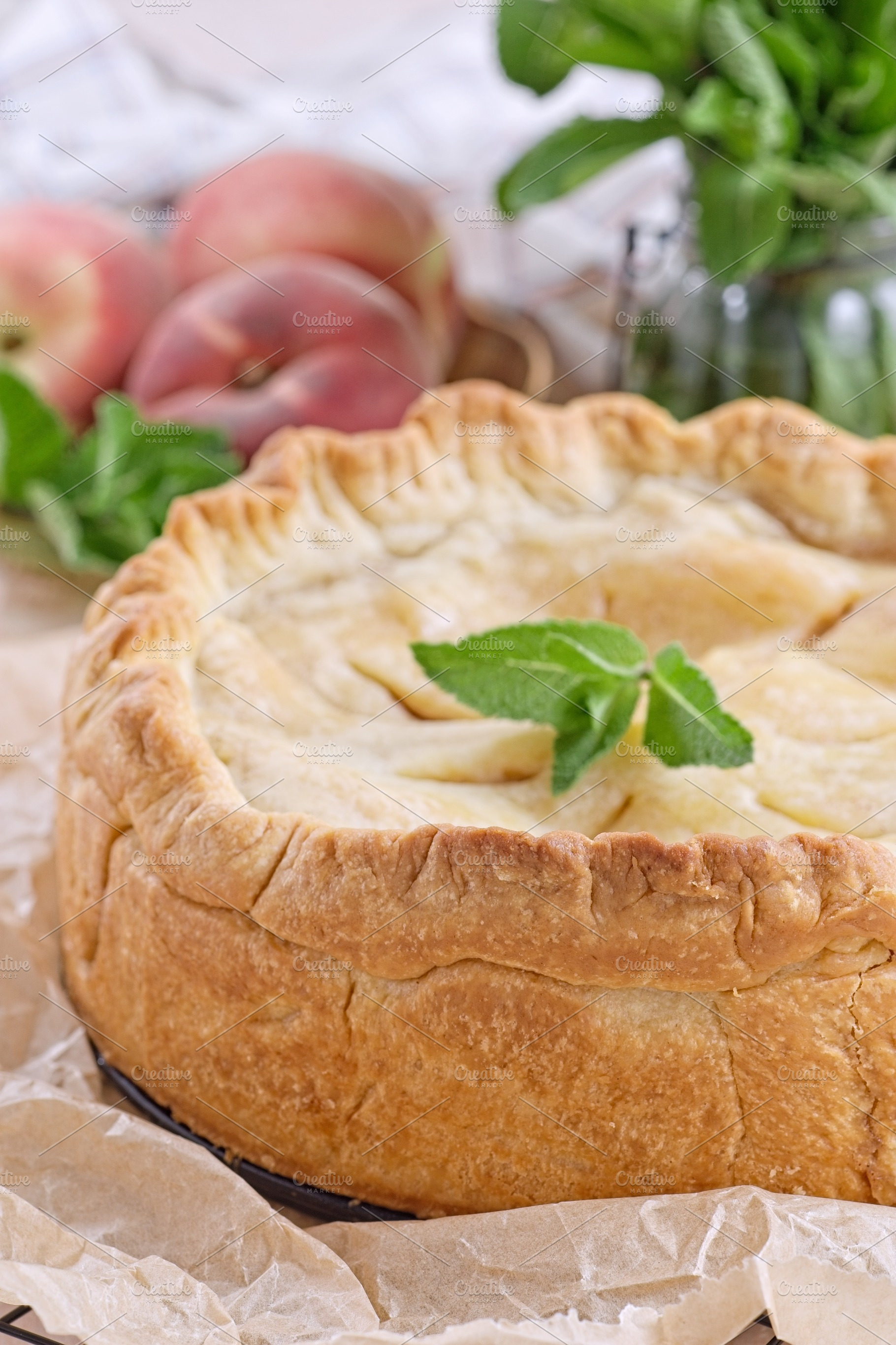 Old fashioned deep dish peach pie cooling on baking rack, vertical, a Food & Drink Photo by iuliia_n