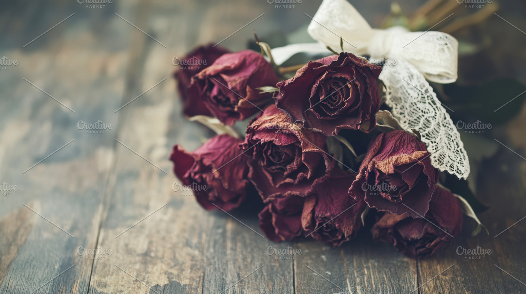 Dried roses with lace ribbon on wood, a Photo by Beautiful things