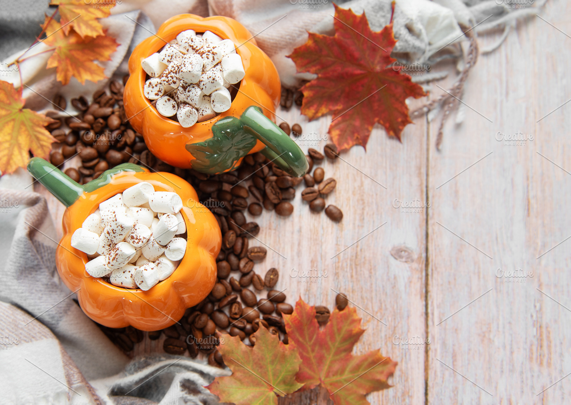 Pumpkin mugs with marshmallows, coffee beans, autumn leaves, a Food & Drink Photo by Olena Rudo