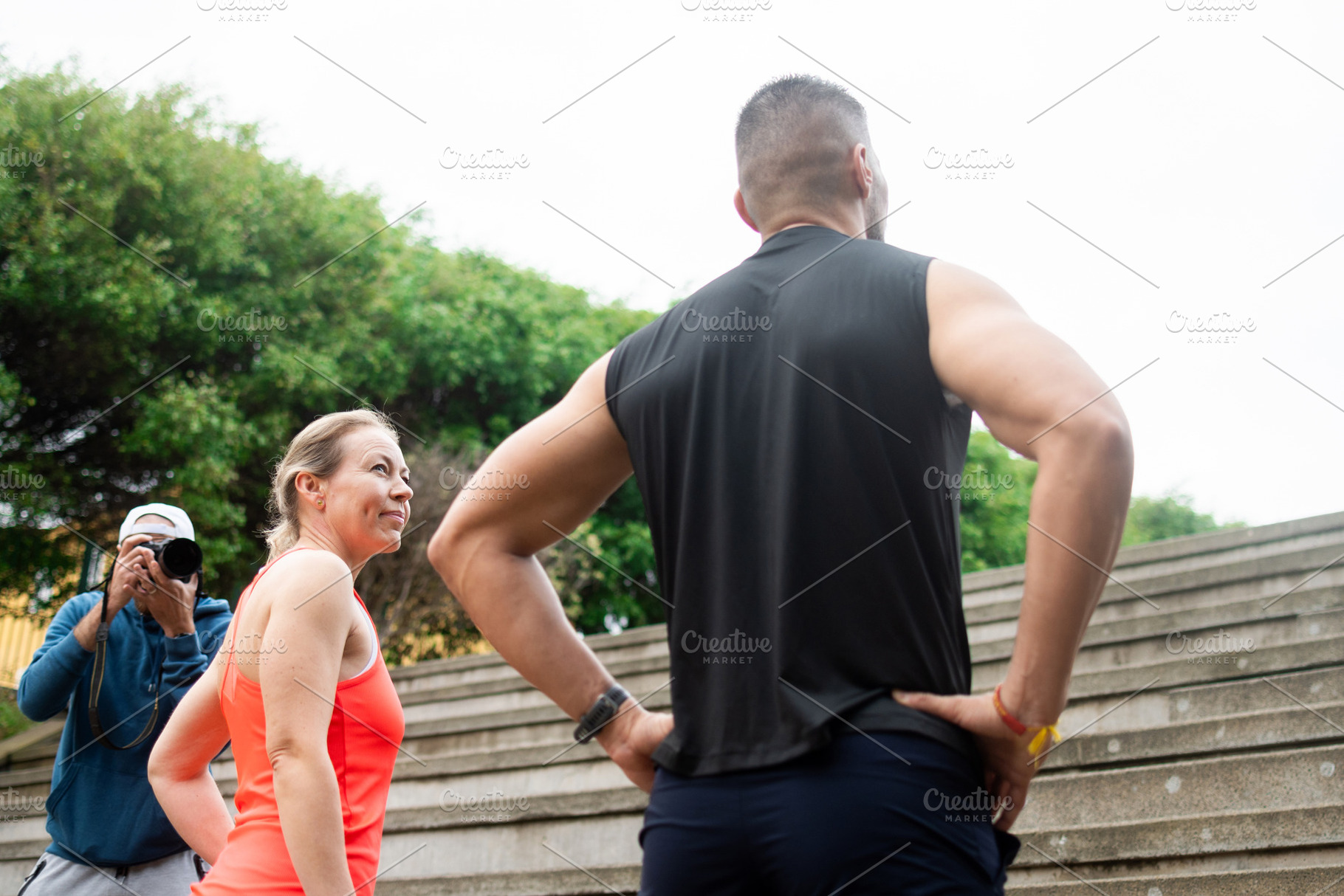 Fitness couple resting after stair workout while photographer captures training, a Sports & Recreation Photo by etorres69