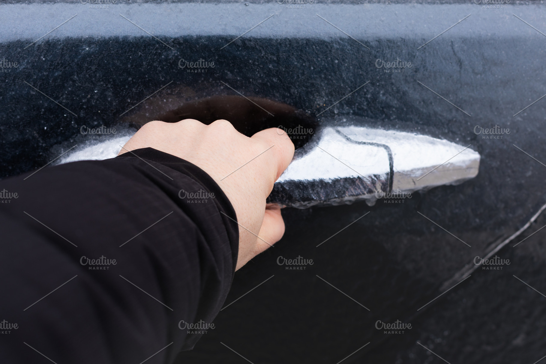 Close-up of a hand gripping an icy car door handle, winter seaso, a Transportation Photo by Ales Munt