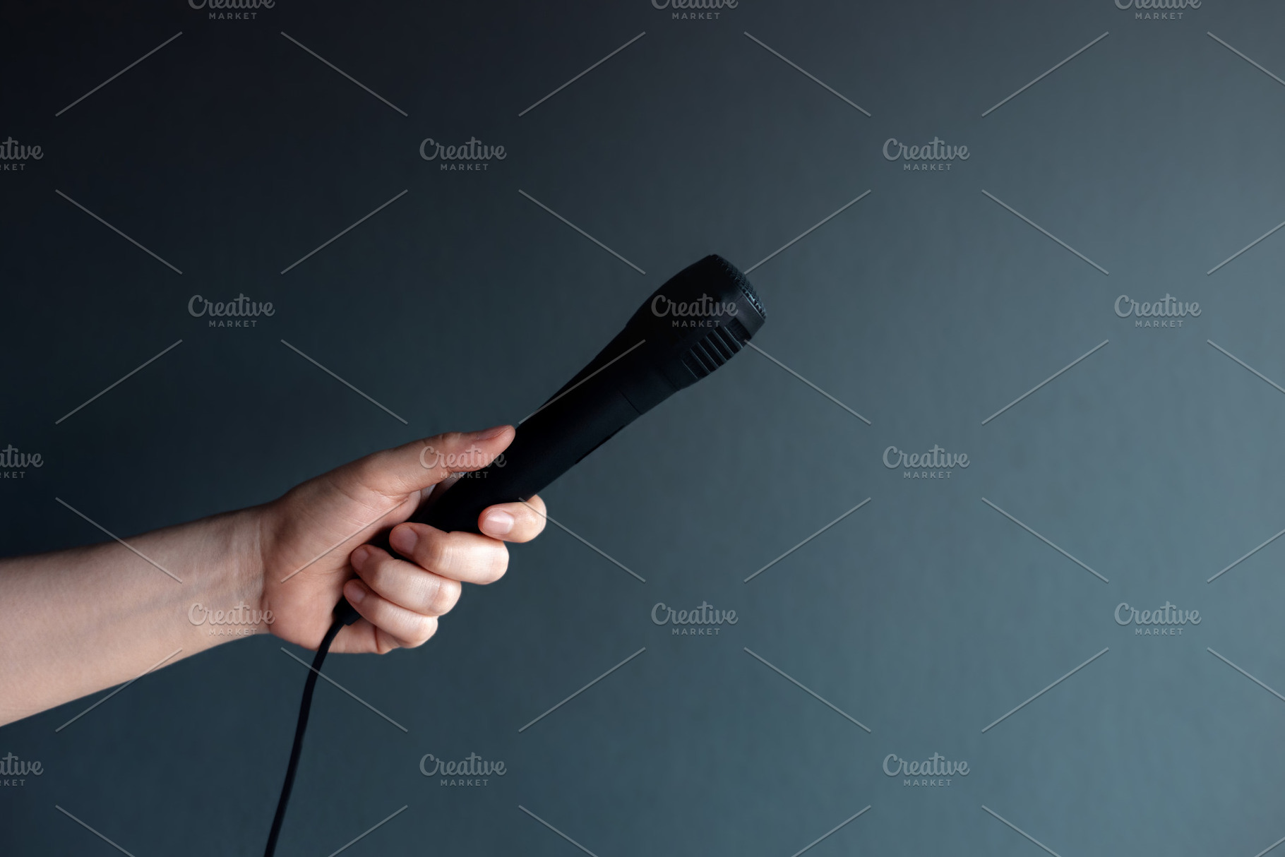 Hand holding microphone, freedom of speech, communication, inter, a Photo by salmon.black