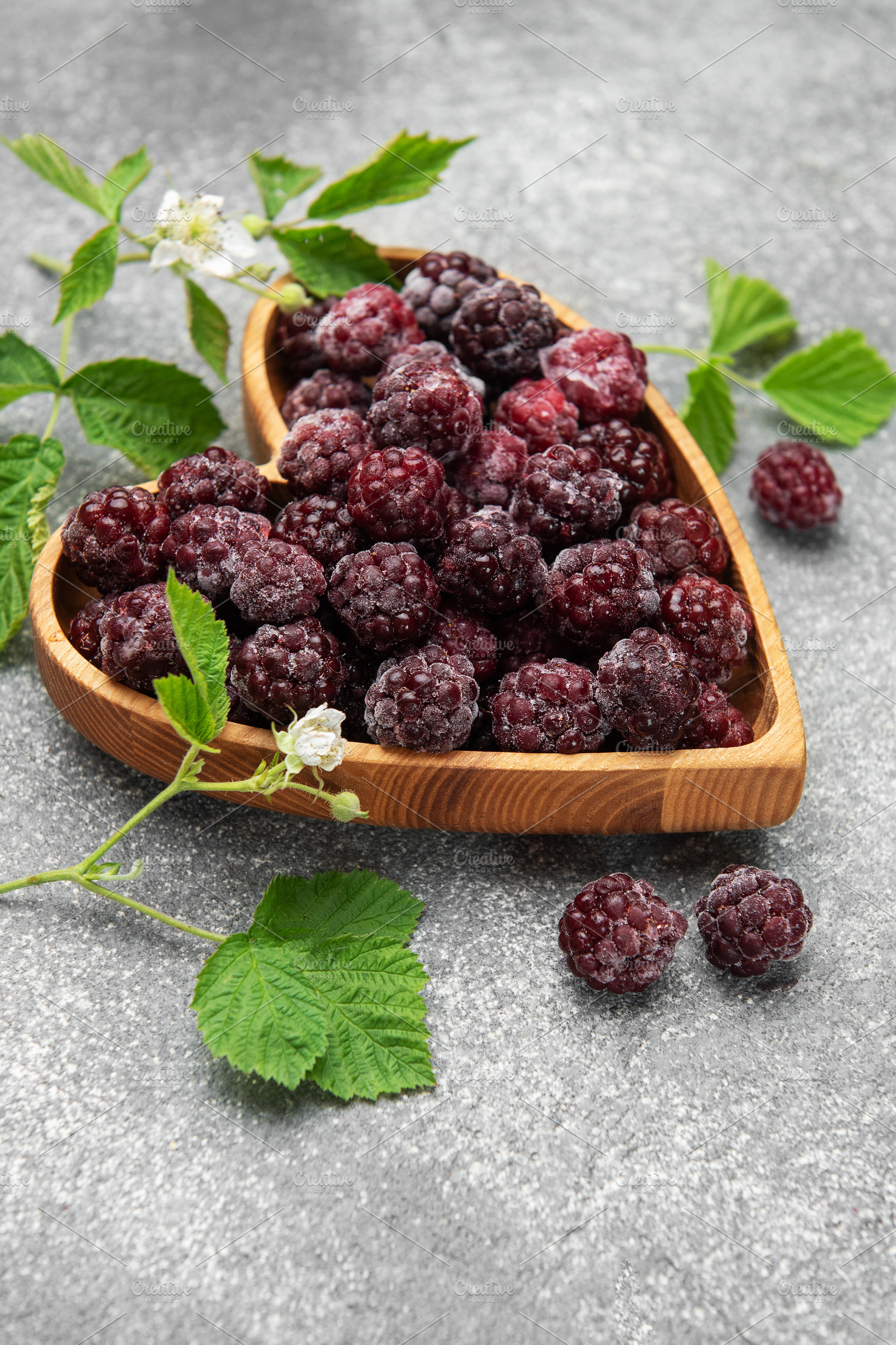 Frozen blackberries in heart shaped wooden bowl, a Food & Drink Photo by Olena Rudo