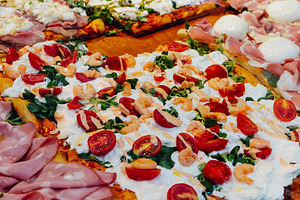pizza al taglio with different toppings in Italy, a Photo by Nito