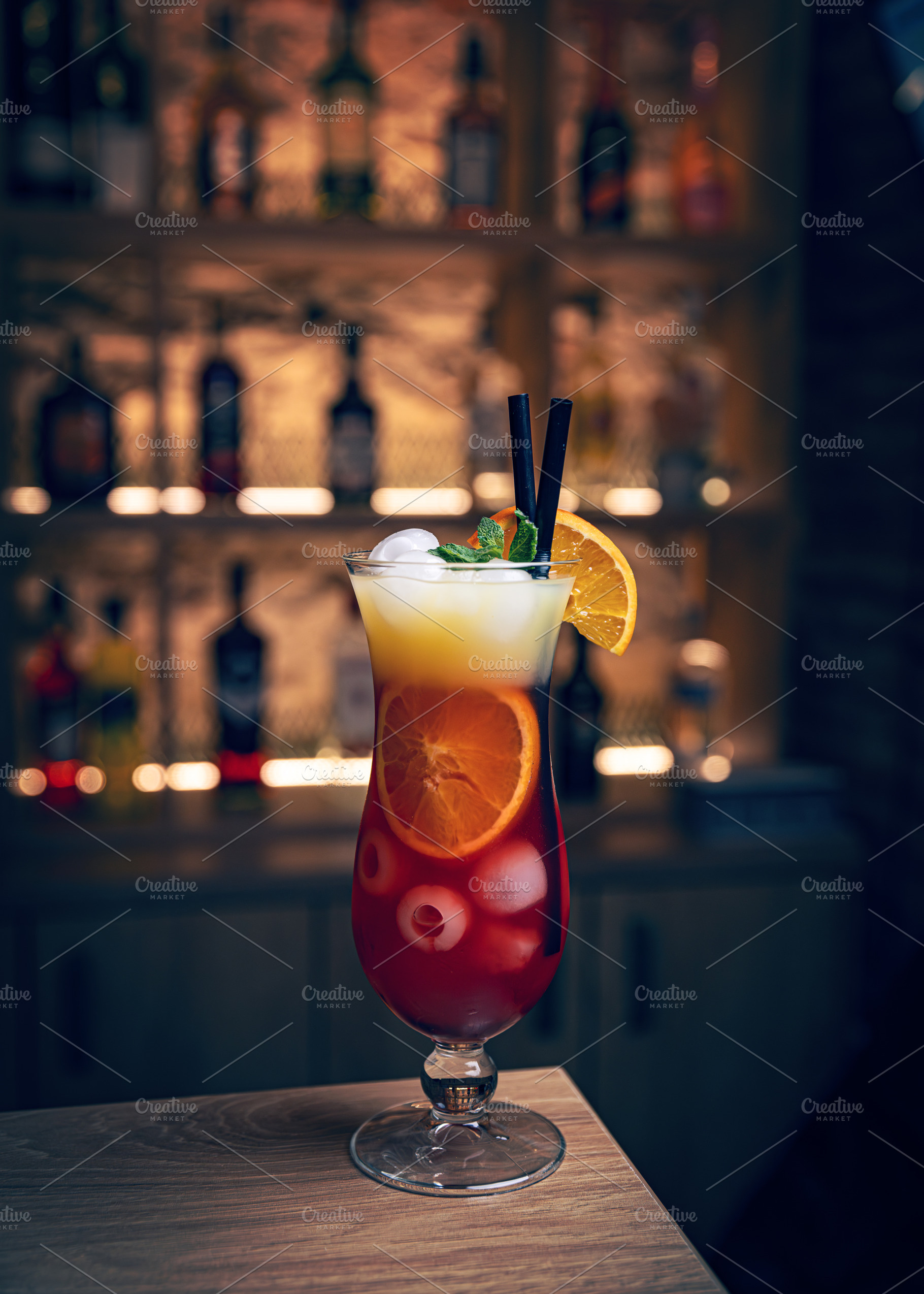 Refreshing cocktail garnished with mint and orange slices, a Photo by Grafvision photography