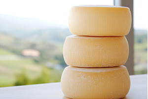 Three stacked wheels of cheese, a Food & Drink Photo by Lermont51