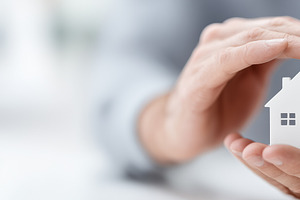 Hands gently holding a small house, a Business Photo by MistyDay