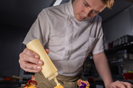 Chef garnishing small dishes, a Photo by Grafvision photography