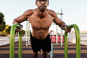 Man doing incline push-ups on parall, a Sports & Recreation Photo by Perpis