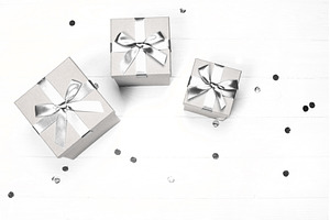 Silver gift boxes and confetti on, a Holiday Photo by Anna Efetova