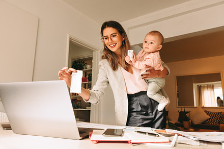 Happy working mom holding a fabric swatch during a video call, a Person Photo by Jacob Lund